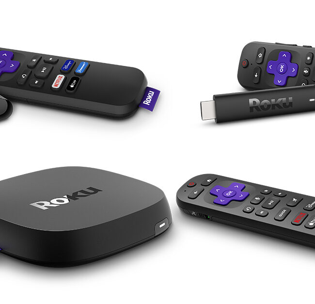 Various Roku streaming devices and their remotes displayed on a white background, including a Roku streaming stick, a small Roku box, and a larger Roku player, each paired with a black remote featuring purple directional buttons and dedicated streaming service keys.